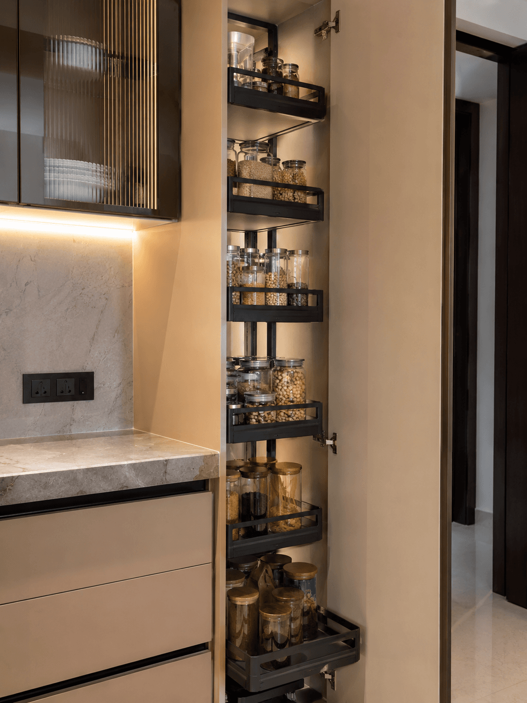 Full-height pantry pull-out with shelves of bottles and labelled jars